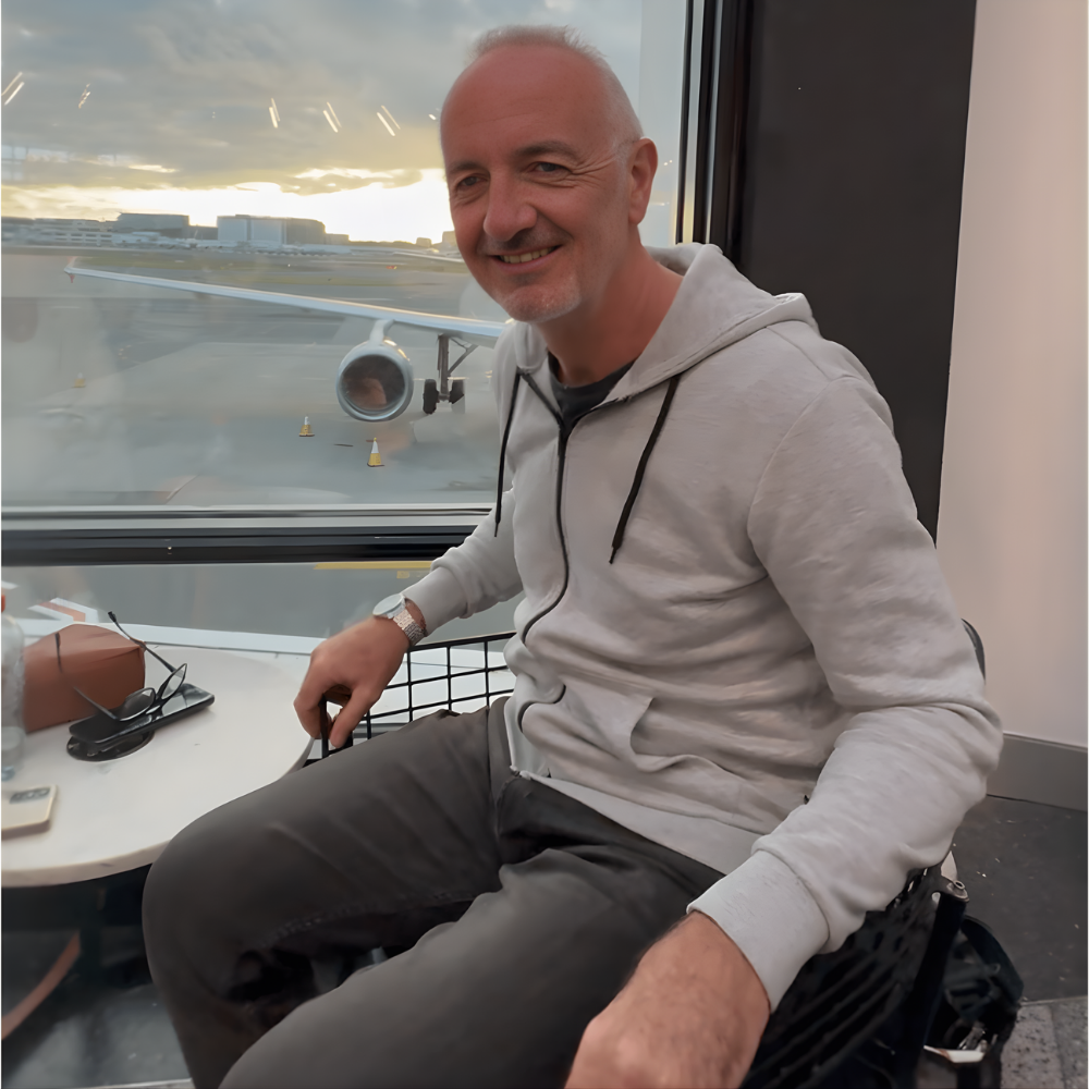 Traveler sitting at airport before flight representing long travel waiting time and need for comfortable seating support